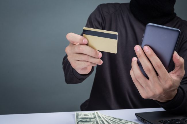 thieves-wear-black-hat-hold-phone-smart-card-gray