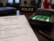 Criminal fingerprinting in Ontario appointment paperwork beside a fingerprint scanner